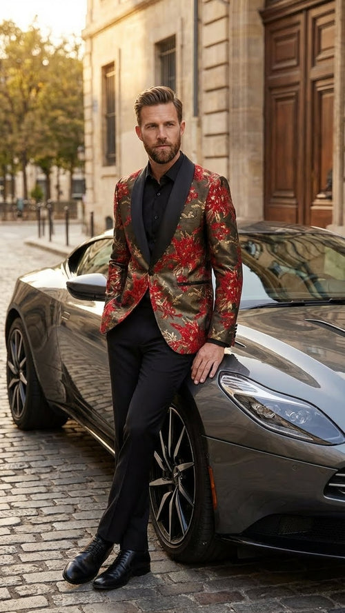 Men's formal shawl lapel blazer. Red & gold floral paisley pattern on a dark backdrop. Fitted silhouette with wide, shawl lapels. Textured fabric enhances the shiny design.
