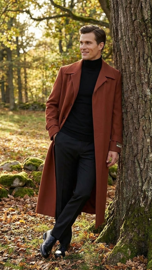 Alberto Nardoni men's cognac overcoat. Straight cut, wide collar, and front buttons. Solid cognac fabric with a smooth texture. Long, fitted sleeves and mid-calf length for a streamlined silhouette.
