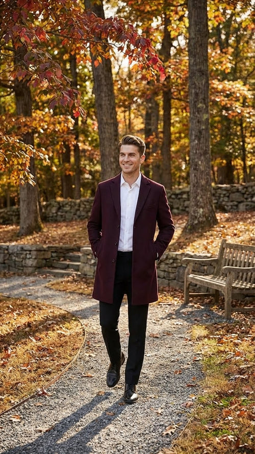 Alberto Nardoni men's burgundy mid-length overcoat. Straight cut, single-breasted, notched lapels. Wool blend, smooth texture. Clean silhouette, knee-length. Visible buttons, side seam pockets.
