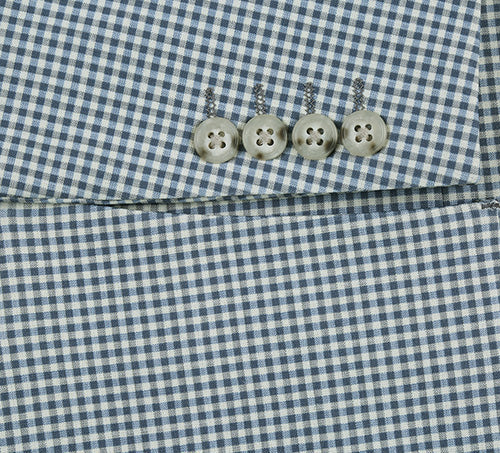 Sage blue check blazer. Slim fit, textured fabric. Four sleeve buttons with flower design. Half canvas construction.
