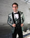 Men's one-button tuxedo: Shiny green organic print jacket with cracked pattern, black velvet shawl collar. Includes green vest and black trousers.
