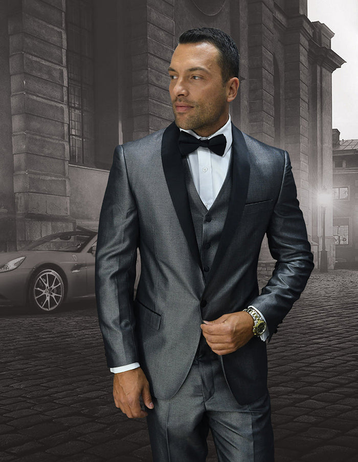 Men's grey shiny prom tuxedo with a one-button closure, shawl lapels, and a matching vest. Features a modern, fitted silhouette with well-defined shoulders and tapered pants. Smooth, shiny fabric.
