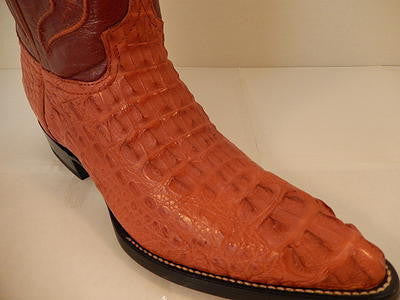 Cognac crocodile skin Wild West boots. Pointed toe, smooth black sole. Textured upper with scales. Dark leather panel on the shaft's top.

