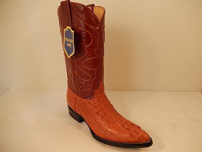 Cognac crocodile leather Wild West boots. Textured upper, brown leather shaft with stitching, pointed toe, high heel, and smooth sole.
