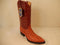 Cognac crocodile leather Wild West boots. Textured upper, brown leather shaft with stitching, pointed toe, high heel, and smooth sole.
