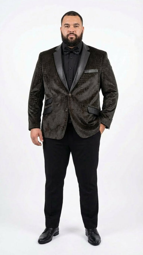 Dark brown men's blazer with crocodile/alligator skin texture, glossy finish, and black satin lapels. Structured shape, front pockets. Worn with black trousers and shoes.
