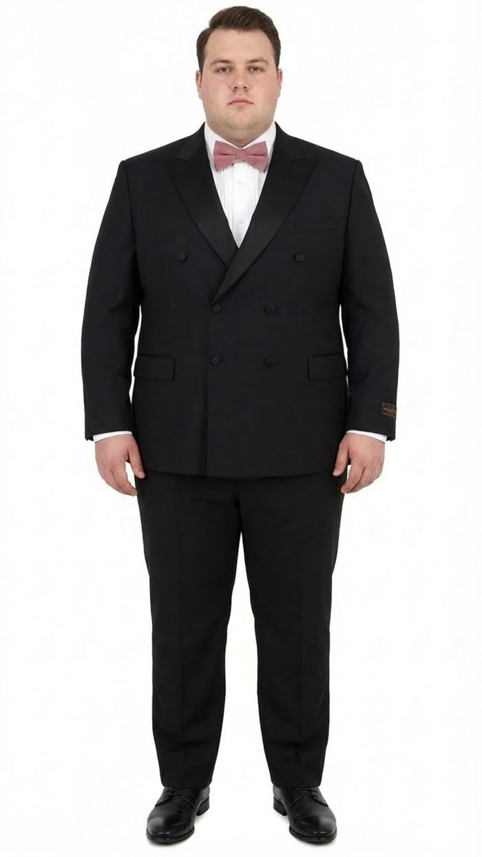Elegant black double-breasted tuxedo in Italian Super 150s wool. Features peaked lapels & structured fit. Paired with white shirt, pink bow tie, and tapered trousers. Black dress shoes complete the look.