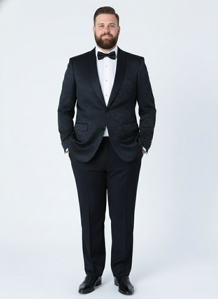 Men's black tuxedo suit with textured paisley floral design. Tailored jacket: satin lapels, single-button closure. Matching trousers. Subtle floral pattern throughout.
