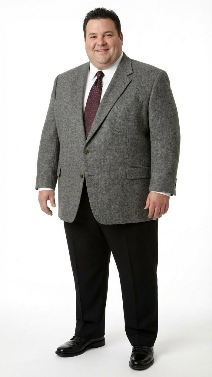Men's charcoal grey blazer. Structured, single-breasted, two-button front, wide lapels. Textured, possibly wool fabric with a subtle pattern. Features welt pockets.
