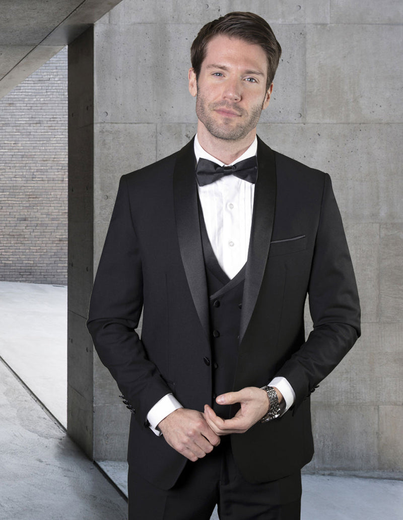 Black wool tuxedo with shawl collar and one-button closure. Includes a matching double-breasted vest with satin details. Tailored fit for a sophisticated look.
