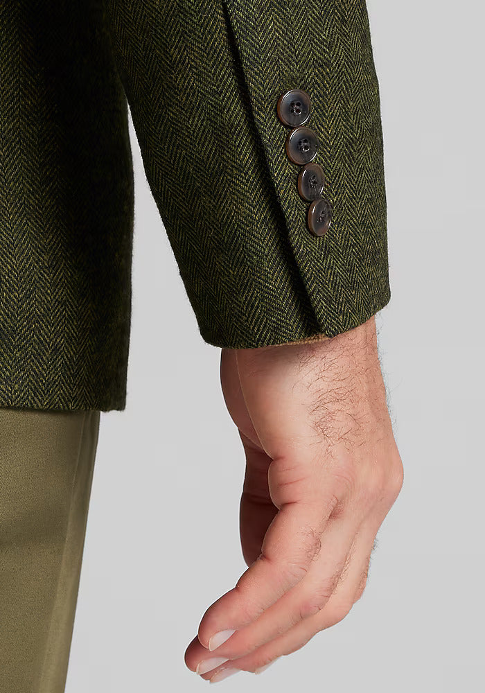 1905 sportcoat. Dark green herringbone with lighter flecks. Tailored fit, structured silhouette. Four dark cuff buttons.