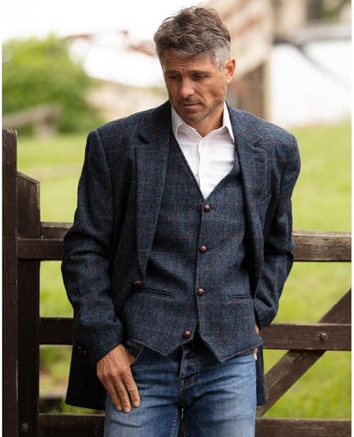 Alberto Nardoni's Walker & Hawkes Blakemore blazer: men's tailored Harris Tweed, structured design. Textured blue wool with flecks. Notch lapel, 2 buttons, 2 pockets, fitted sleeves.