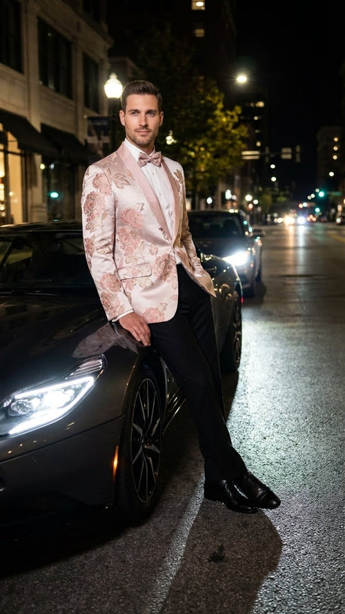 Men's pink blush floral jacquard blazer. Features embellished shawl lapel, tailored fit, and intricate pink/cream floral patterns on a light background.
