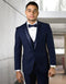 Navy wool tuxedo with modern fit. Features a shawl lapel, single-button closure, and side pockets. Tailored silhouette crafted from a wool blend. Sleek cuffs.
