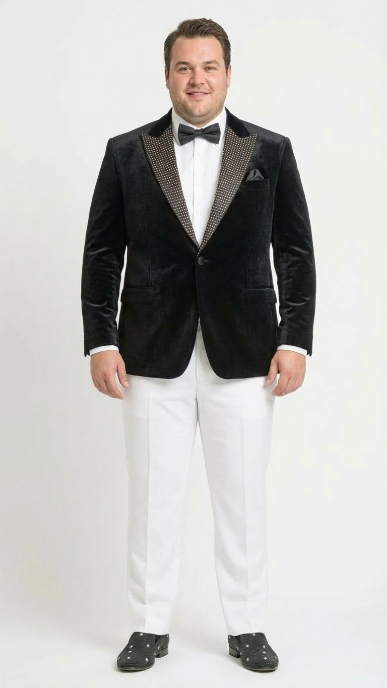 Black velvet tuxedo blazer. Fitted, deep black. Studded lapel contrasts the plush velvet. Classic style with two front pockets.
