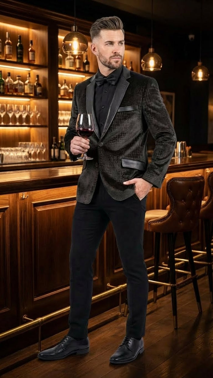 Men's dark blazer with reptile skin texture. Features a textured pattern, likely crocodile/alligator. Includes a satin black lapel and pockets.
