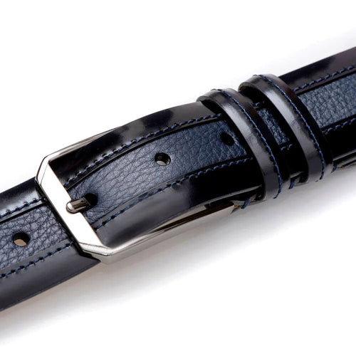 Blue Mezlan deerskin belt with silver buckle. Smooth finish, perforated for adjustment, contrasting stitching. Durable and stylish.
