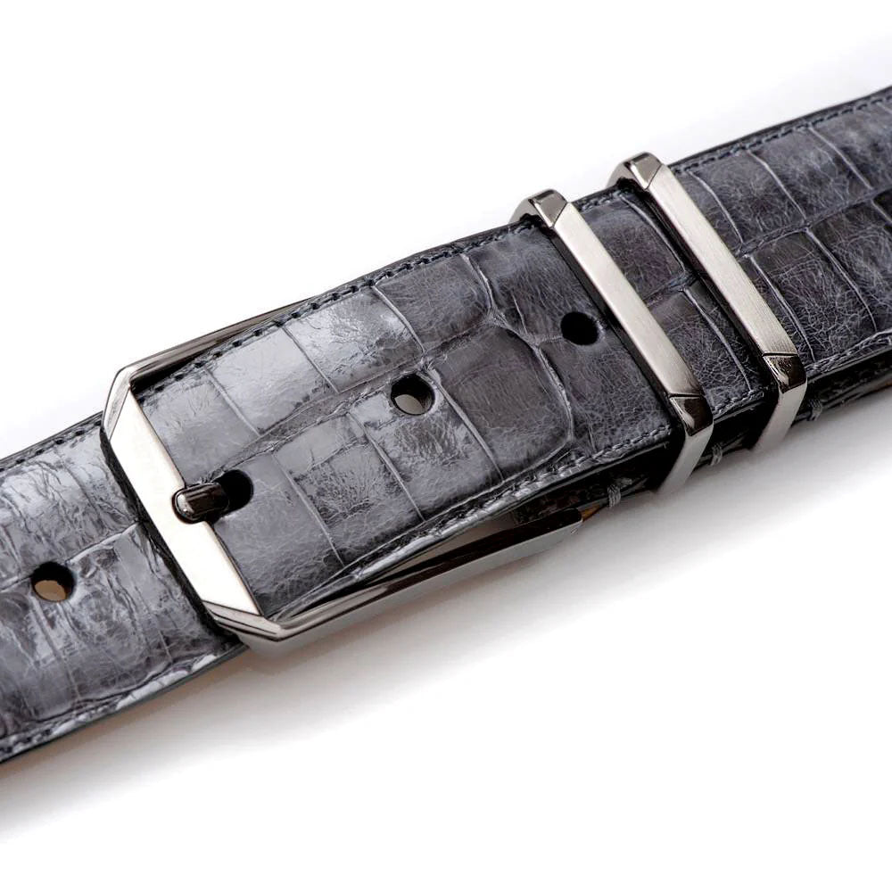 Grey Mezlan crocodile-textured belt. Smooth finish, silver-tone rectangular buckle, and two keepers. Adjustable fit with multiple holes.
