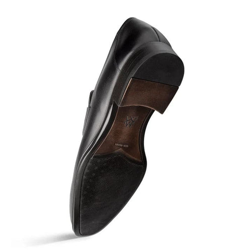 Sleek black Mezlan Avenue penny loafer. Rounded toe, low profile, and low heel. Dark sole with smooth heel and textured traction. Classic penny slot detail on the vamp.
