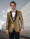 Gold diamond-print tuxedo. Fitted jacket with black lapel, matching vest, and classic-cut black trousers. Shiny gold fabric.
