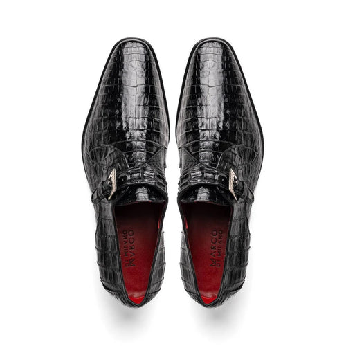 Black caiman crocodile leather dress loafers with single monk strap. Pointed toe, textured scale pattern, adjustable metal buckle. Red interior lining.
