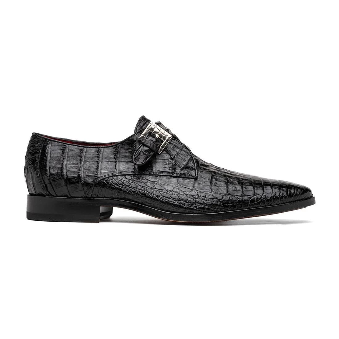 Genuine black caiman crocodile dress loafers. Single monk strap, pointed toe, silver buckle. Textured scale pattern. Low square heel.

