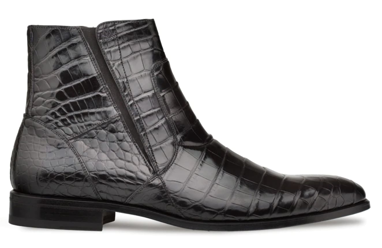 Belucci Black Alligator Zipper Boot: Ankle-height, pointed-toe design with a glossy black finish. Genuine alligator leather upper with a unique scale pattern. Side zipper closure and flat black sole. Tailored, contoured edges.
