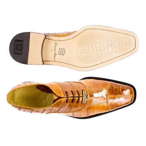 Tan eel and ostrich leather dress shoe with cap toe. Pointed shape, glossy finish, contrasting black sole. Luxurious and stylish.

