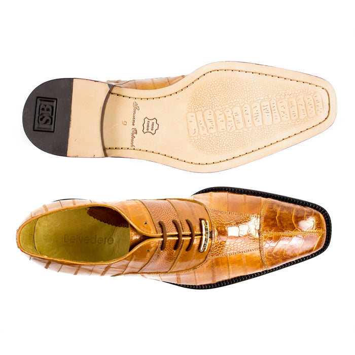 Tan eel and ostrich leather dress shoe with cap toe. Pointed shape, glossy finish, contrasting black sole. Luxurious and stylish.
