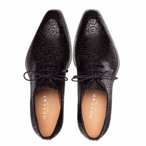 Mezlan Lontani brogue derby shoes with black/burgundy patina. Pointed toe, textured leather, floral pattern. Black upper with burgundy accents, central lacing.
