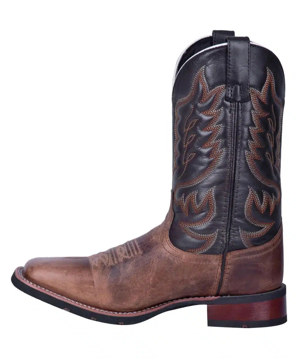 Laredo Men's Montana Boot: Tall boot with brown distressed leather and black shaft featuring detailed stitching. Pointed toe, low heel with lift, and pull tab for easy wear.
