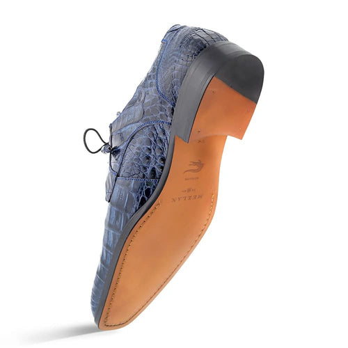 Mezlan Anderson exotic men's shoe. Blue crocodile leather with glossy finish, structured lace-up. Features ornate texture, tapered toe & contrasting brown curved leather sole.
