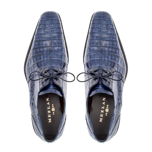 Mezlan Anderson men's shoes: Glossy blue crocodile leather upper with textured pattern. Classic lace-up design and elongated shape. Black leather interior, sleek flat sole for a refined look.
