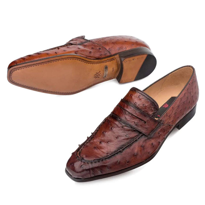 Mezlan Lisbon slip-on loafer in brandy ostrich leather. Features a rounded, slightly pointed toe and stitched seam. Rigid sole with tan upper and black rubber tip. Low-profile heel.
