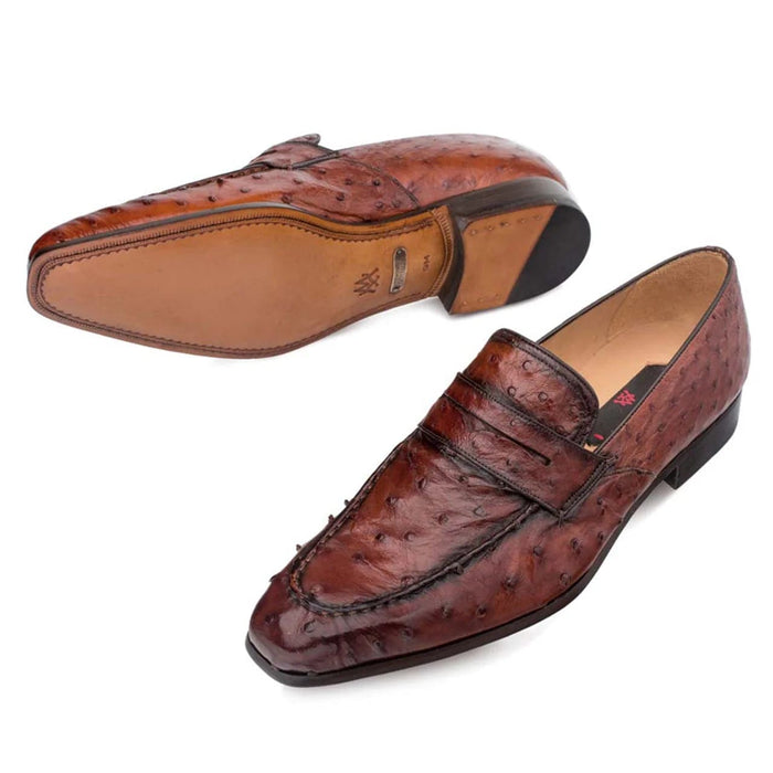 Mezlan Lisbon slip-on loafer in brandy ostrich leather. Features a rounded, slightly pointed toe and stitched seam. Rigid sole with tan upper and black rubber tip. Low-profile heel.
