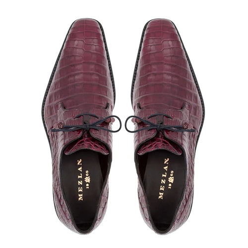 Burgundy crocodile Mezlan Anderson lace-up shoes with pointed toe and sleek silhouette. Feature textured scaled pattern, black laces, gold branding inside, and contrasting black sole.
