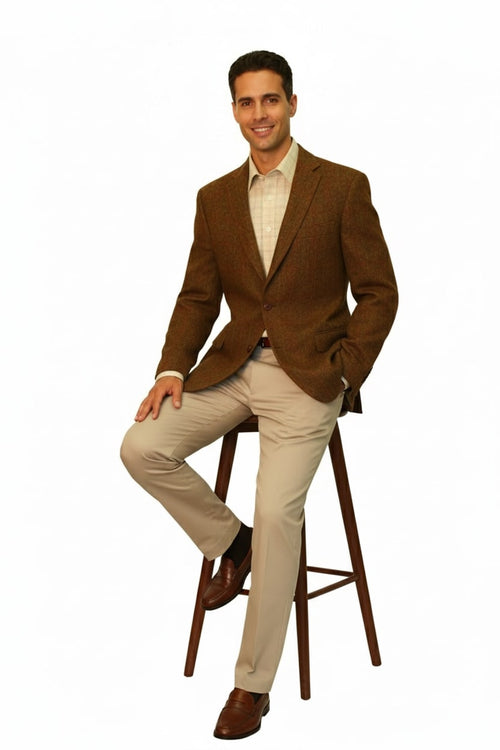 Men's Alberto Nardoni burnt orange Harris Tweed blazer. Structured fit, notched lapels, two buttons. Textured fabric with subtle pattern. Features side pockets and classic cut for a tailored, sophisticated look.
