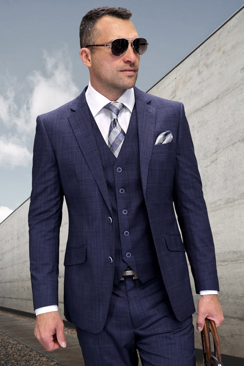 Navy blue modern fit men's suit. Designer wool sharkskin with a fitted jacket, notched lapel, and patterned vest. Matching trousers complete the look. Subtle sheen and textured pattern.
