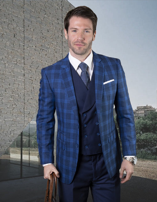 Men's classic fit, double-breasted vest suit in sapphire plaid. Fitted silhouette with a textured blend. Vibrant sapphire blue with a plaid pattern in varying blue shades & black accents. Features a matching suit jacket.
