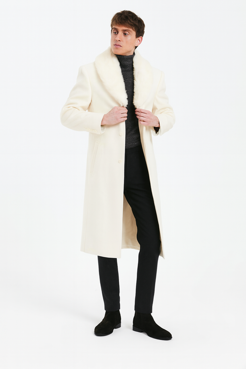 Men's ivory cream overcoat with faux fur shawl collar. Full-length, straight silhouette, double-button closure. Luxurious and structured design.
