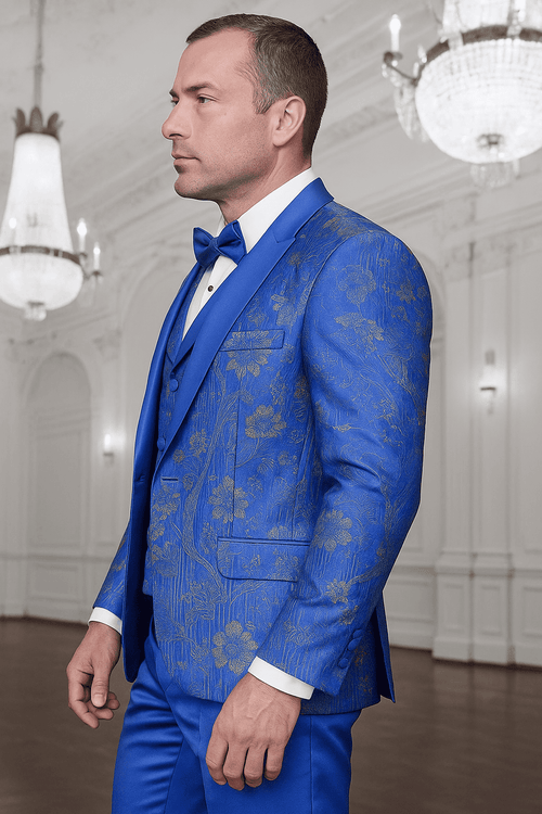 Royal blue paisley tuxedo with double-breasted vest. Structured blazer, sharp lapel, fitted silhouette. Gold paisley pattern accents. Matching double-breasted vest. Elegant, tailored fit.

