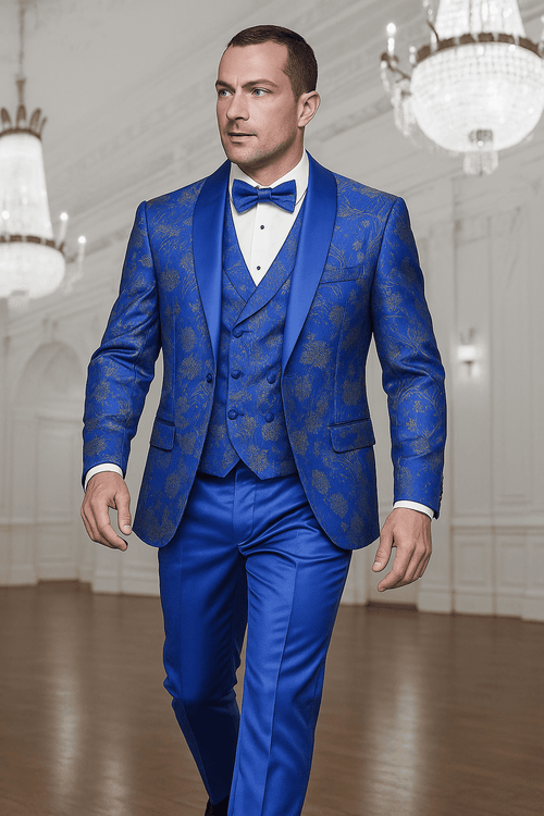 Royal blue paisley tuxedo. Double-breasted vest with gold paisley, satin details, and tailored trousers. Intricate lace print adds elegance.
