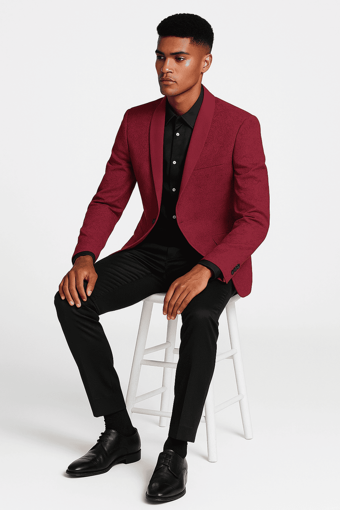 Burgundy paisley slim-fit tuxedo jacket. Structured with a notched lapel. Textured fabric with intricate paisley pattern. Burgundy with a contrasting dark shawl collar.
