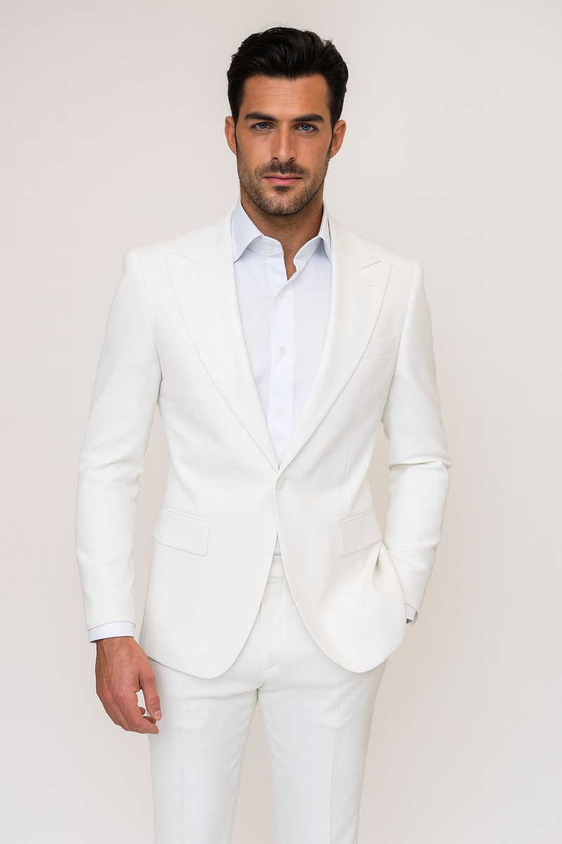 White seersucker suit with peak lapels. Fitted jacket, two pockets, single button. Slim-fit pants. Classic summer style.
