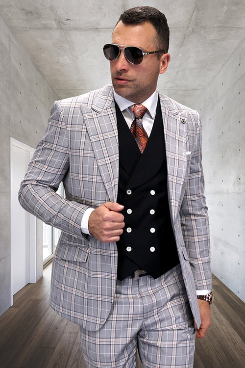 Men's designer black wool suit with windowpane pattern. Features peak lapel, fitted vest, and matching trousers. Tailored, structured design. Formal aesthetic.
