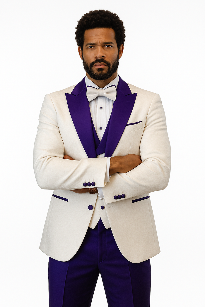 Cream tuxedo jacket with purple peak lapel, matching vest & pants. Features purple button & pocket detailing. Complete with bow tie.
