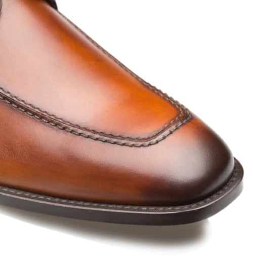 Coventry cognac oxford shoes with gradient calfskin uppers, pointed toe, and visible stitching. Rounded heel and contrasting sole offer a structured silhouette.
