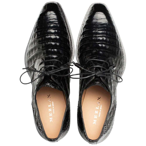 Mezlan men's Cratos derby shoes in black crocodile leather. Pointed toe, lace-up design with central laces. Light lining complements the dark exterior.
