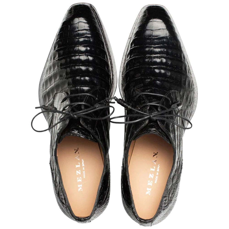 Mezlan men's Cratos derby shoes in black crocodile leather. Pointed toe, lace-up design with central laces. Light lining complements the dark exterior.
