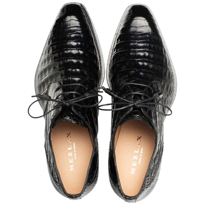 Mezlan men's Cratos derby shoes in black crocodile leather. Pointed toe, lace-up design with central laces. Light lining complements the dark exterior.
